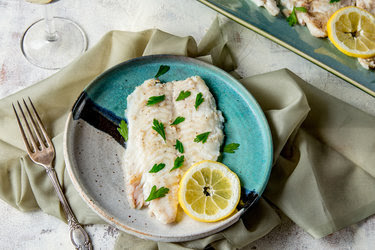 Grilled flounder prepared in a brine and served with lemon.