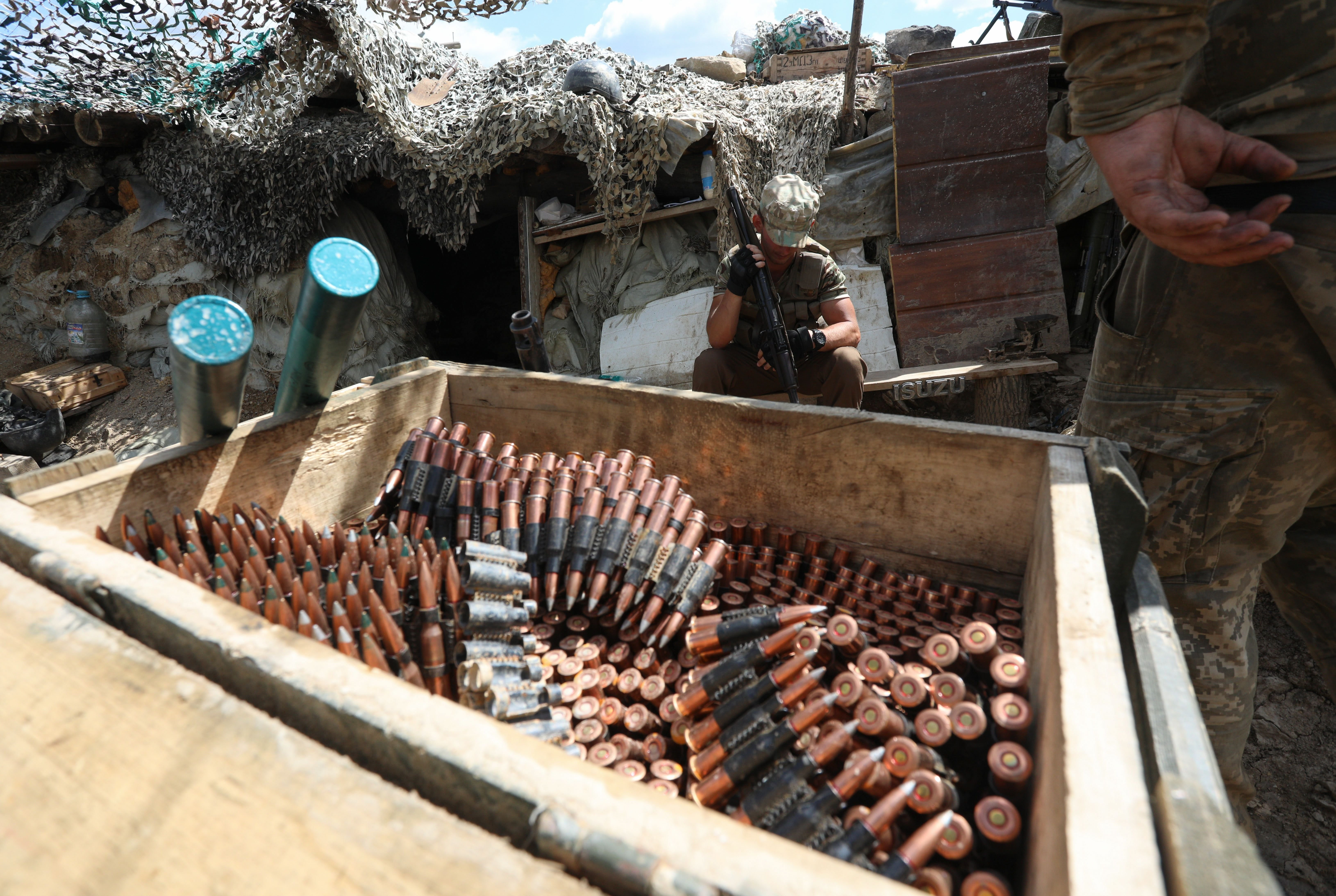 Ukrainian servicemen load weapons while stationed near Donetsk, Ukraine, July 31. Ukrainian servicemen load weapons while stationed near Donetsk, Ukraine, July 31.