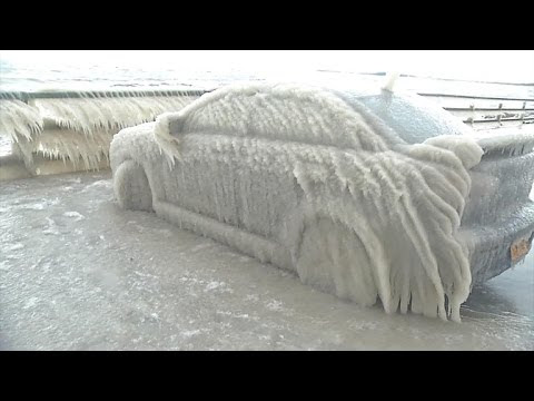 Photo of a car completley covered in ice.