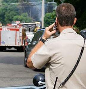 Image of policeman and fire truck