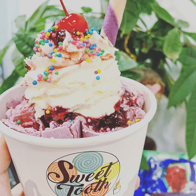 Sweet Tooth ice cram cup with vanilla ice cream, sprinkles and a cherry on top