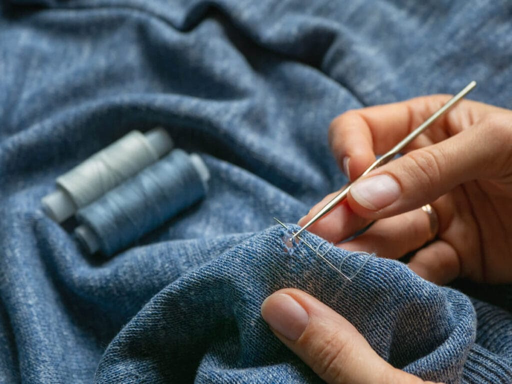 Repairing clothes instead of buying new is a great sustainable living tip. Get more eco friendly tips here.