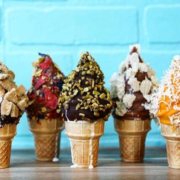 multiple ice cream cones with different toppings