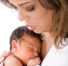 A woman holding her newborn baby.  
