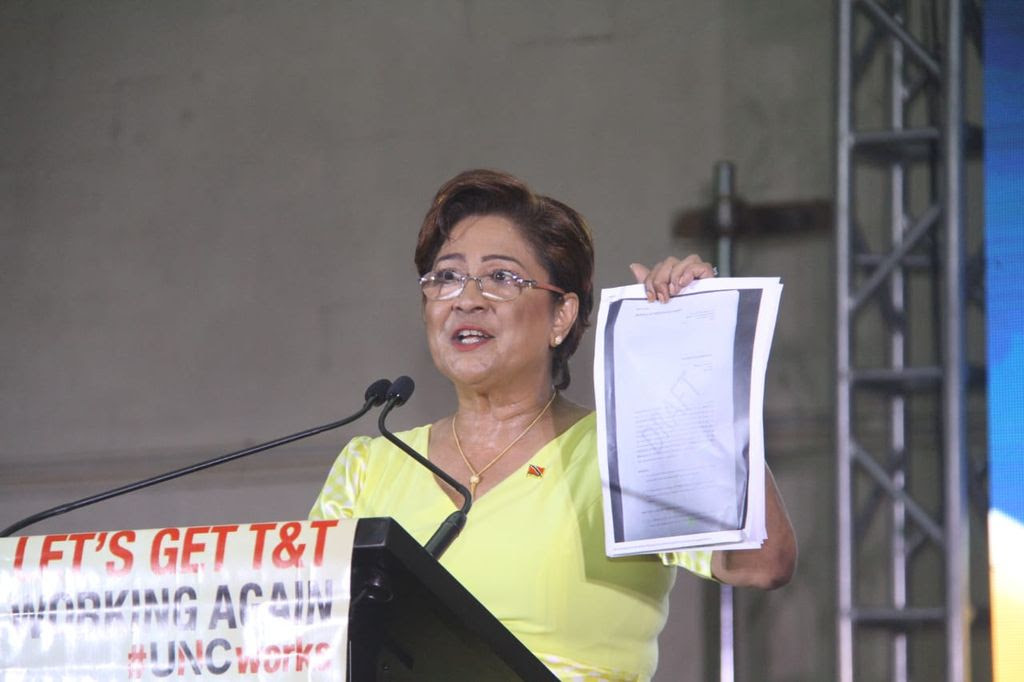 Opposition Leader Kamla Persad-Bissessar displays a document as she addresses the UNC Monday Night Forum in Fyzabad.