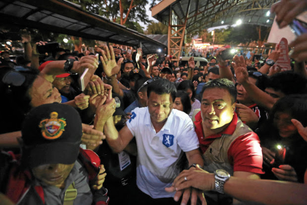 DAVAOCityMayor Rodrigo Duterte is greeted by supporters at Lipa City Hall in Batangas province during a campaign sortie. RAFFY LERMA