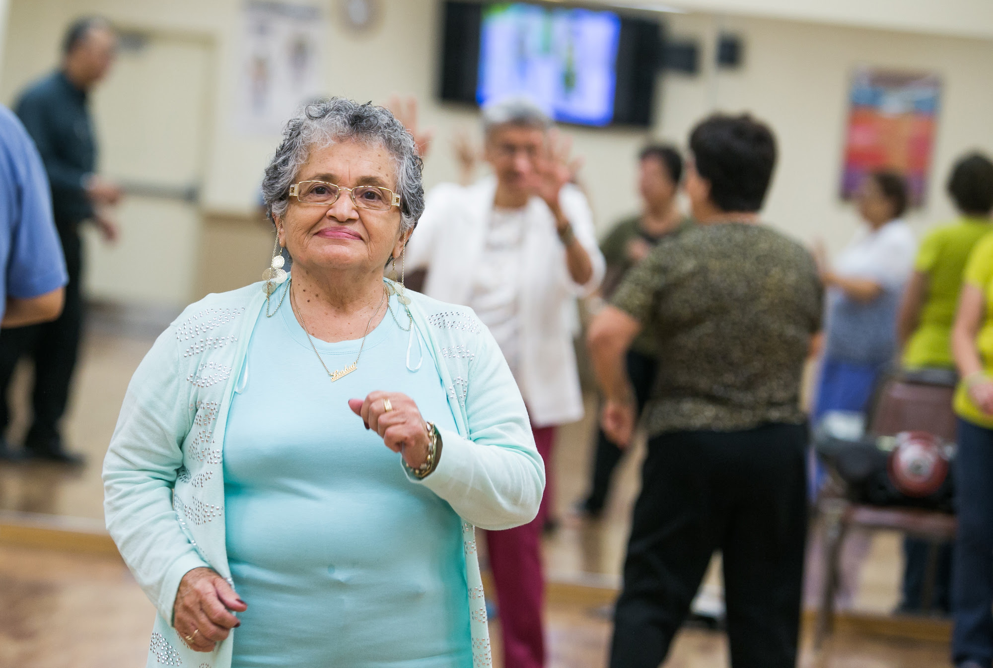 Dancing older woman at a senior center