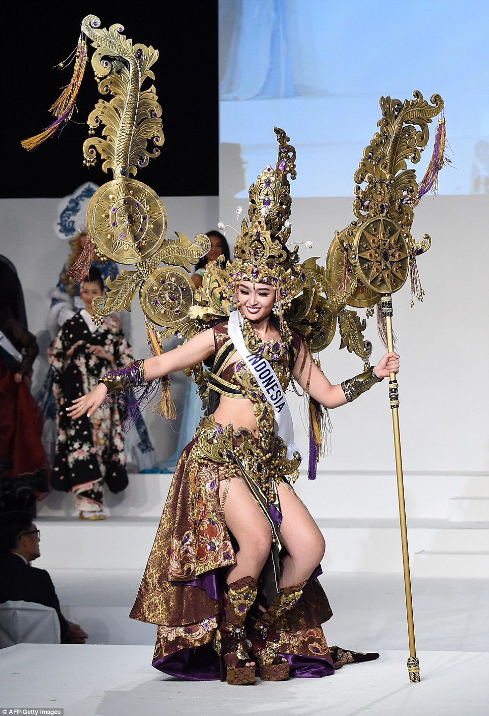 Another intricate costume came from Miss Indonesia, Chintya Fabiola. Inspired by the traditional dress worn by folk dancers, Chintya made a few moves herself, using her embellished staff as a prop. Her tall gold headdress was complemented by two gold tassled 'wings', a collar, a belt, cuffs and shin-high platform boots