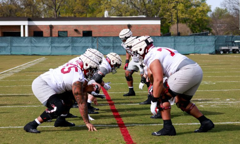 Alabama's offensive line goes through a run blocking drill at practice