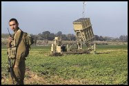 An Israeli soldier standing next to a launcher, part of the 
