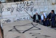Who did it? Arabs sit next to racist graffiti, signed 