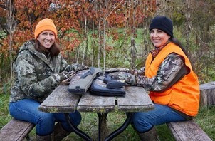 two women hunters sitting at a table