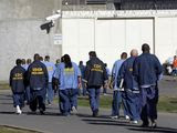 FILE - In this Feb. 26, 2013, file photo, inmates walk through the exercise yard at California State Prison Sacramento, near Folsom, Calif. California arrest rates have dropped nearly 60 percent since 1989, yet blacks are three times more likely to be arrested than whites, according to a report released by the Public Institute of California, Monday Dec. 3, 2018. (AP Photo/Rich Pedroncelli, File)