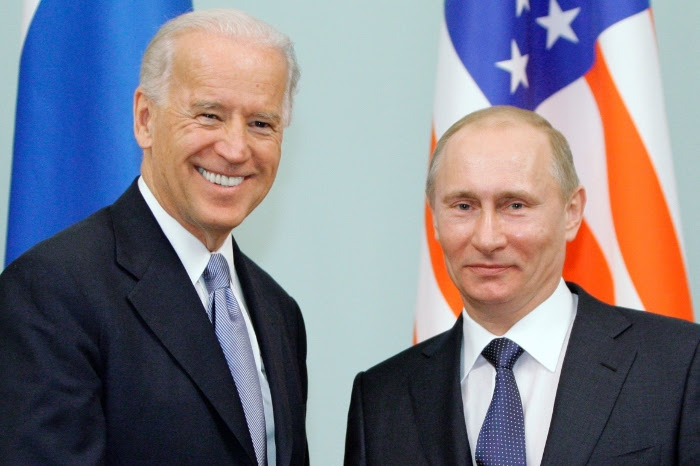 In this March 10, 2011 photo, then-Vice President Joe Biden, left, shakes hands with Russian Prime Minister Vladimir Putin in Moscow.