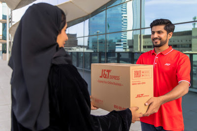 A J&T Express courier delivers a parcel to a resident in Saudi Arabia