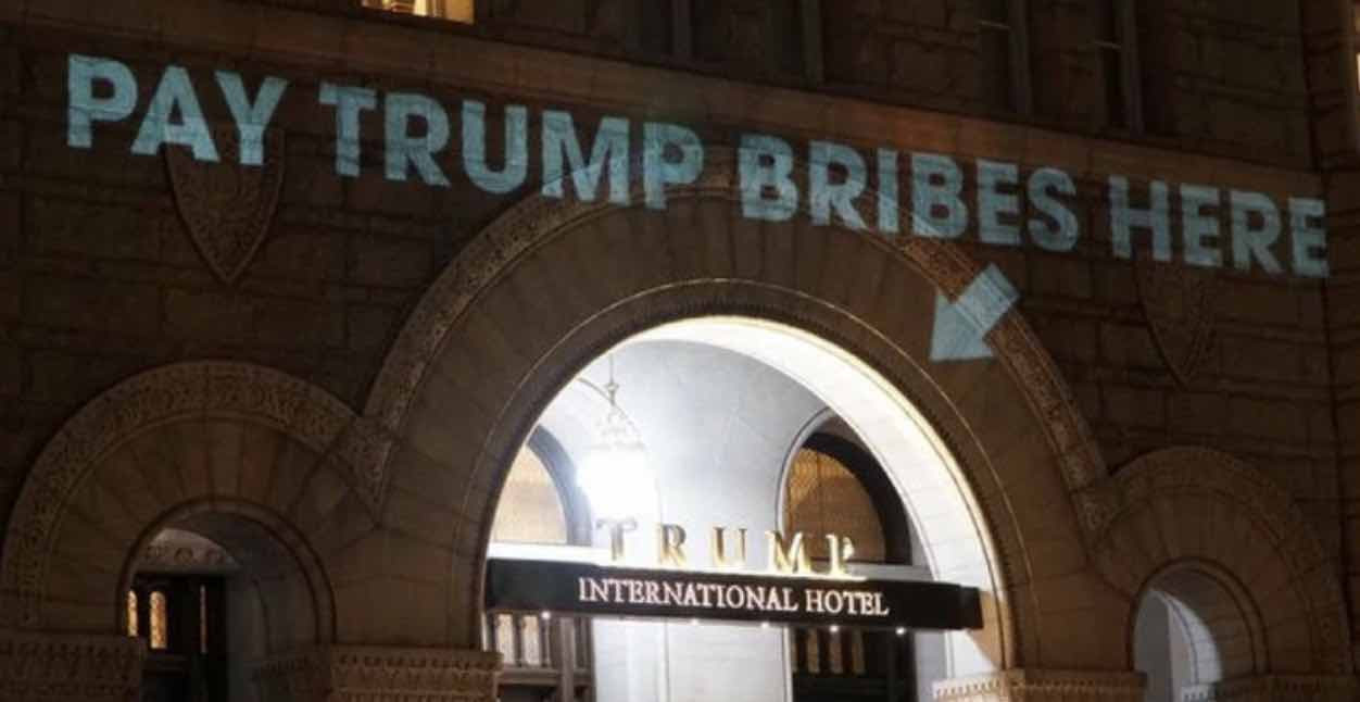 Pay Trump bribes here sign projected