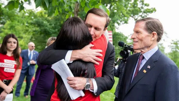 PHOTO: Sen. Chris Murphy hugs Erica Lafferty as Sen. Richard Blumenthal looks on during a rally to demand the Senate take action on gun safety in the wake of the Robb Elementary School shooting in Texas in Washington, May 26, 2022. (Tom Williams/CQ-Roll Call, Inc via Getty Images)