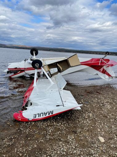 small plane that crashed on the shoreline of a lake