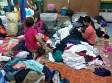 Volunteers sort clothes at the second hand store. From indepthnews.net