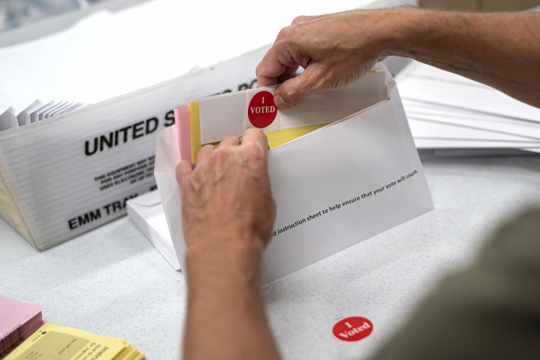 Mail sorting with an I voted sticker