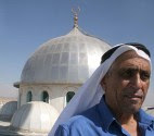 A Bedouin man walks next to a mosque in the Bedouin settlement of Rahat