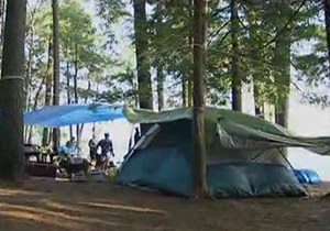 People with a tent at a campground.