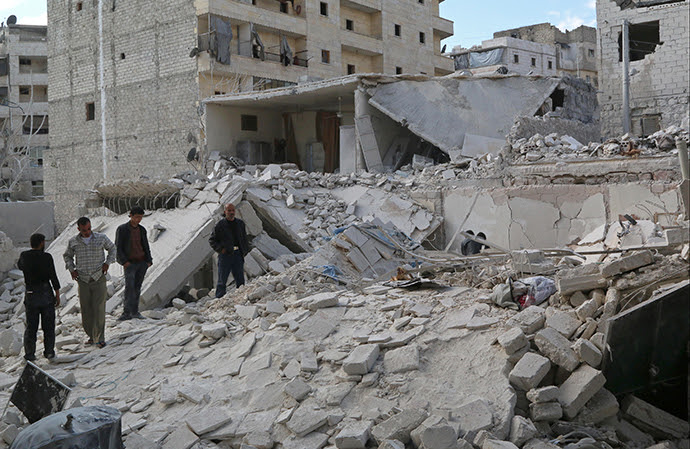 Civilians inspect a site hit by what activists said were barrel bombs dropped by forces loyal to Syria's President Bashar al-Assad in Karam Homad district in Aleppo March 26, 2014. (Reuters / Mahmoud Hebbo)
