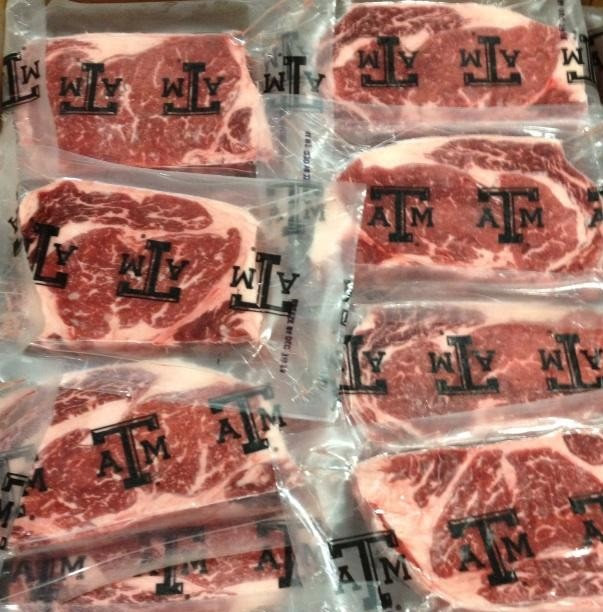 steaks in individual plastic wrap with the Texas A&M brand of a large capital T and a smaller capital A on one side and M on the other side of the T