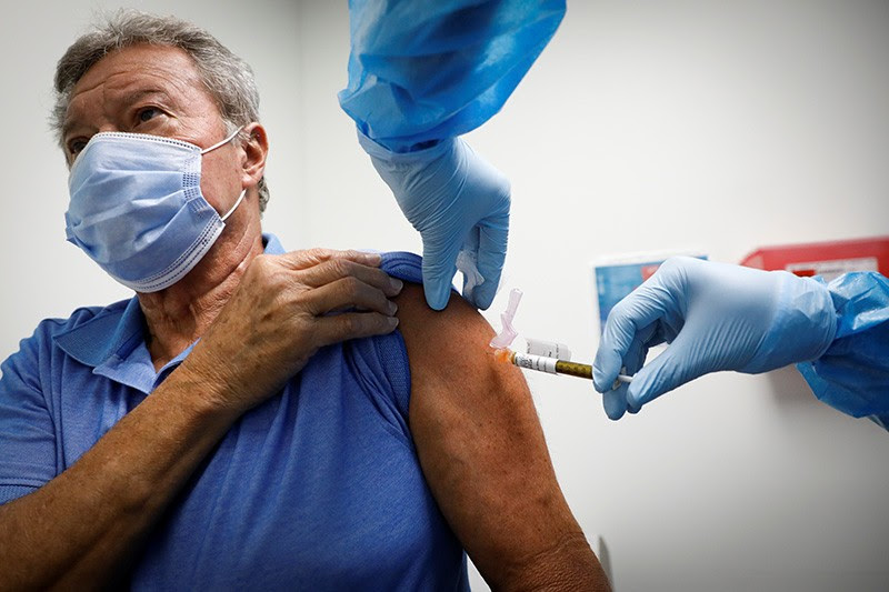 A volunteer is injected with a COVID-19 vaccine for a study in the United States.