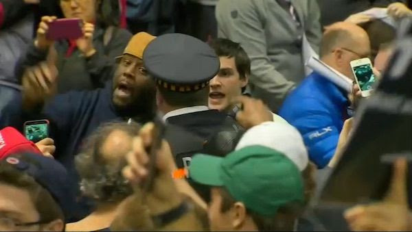 A man argues with a Chicago policeman during the aftermath of a postponed rally for Donald Trump (Photo: NBC 5 Chicago screenshot)