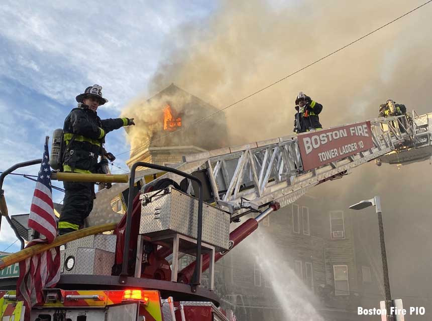 Boston firefighters on tower ladder at three-alarm fire
