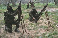 Hamas operatives launching rockets. (file)