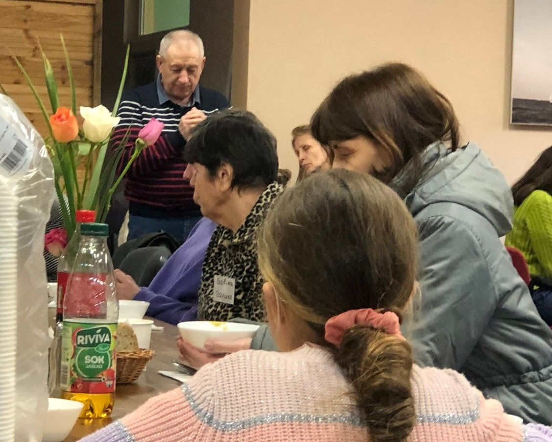 Ukrainian refugees in Sopot, Poland praying before a meal. Picture from Molly Dawidow