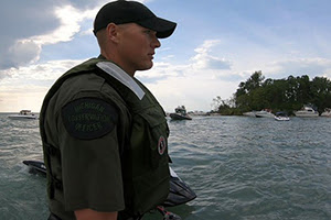 male conservation officer patrolling Lake St. Clair