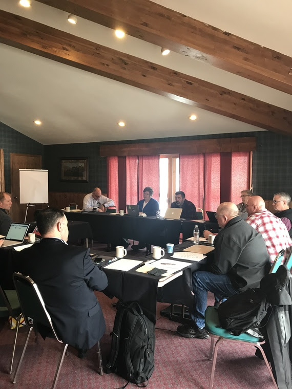 Chief Academic Officer Brent Bacon sits with district superintendents from northeast Wyoming during their conference.