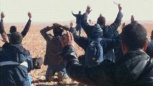 Hostages seen with their hands in the air at the Amenas gas facility in Algeria