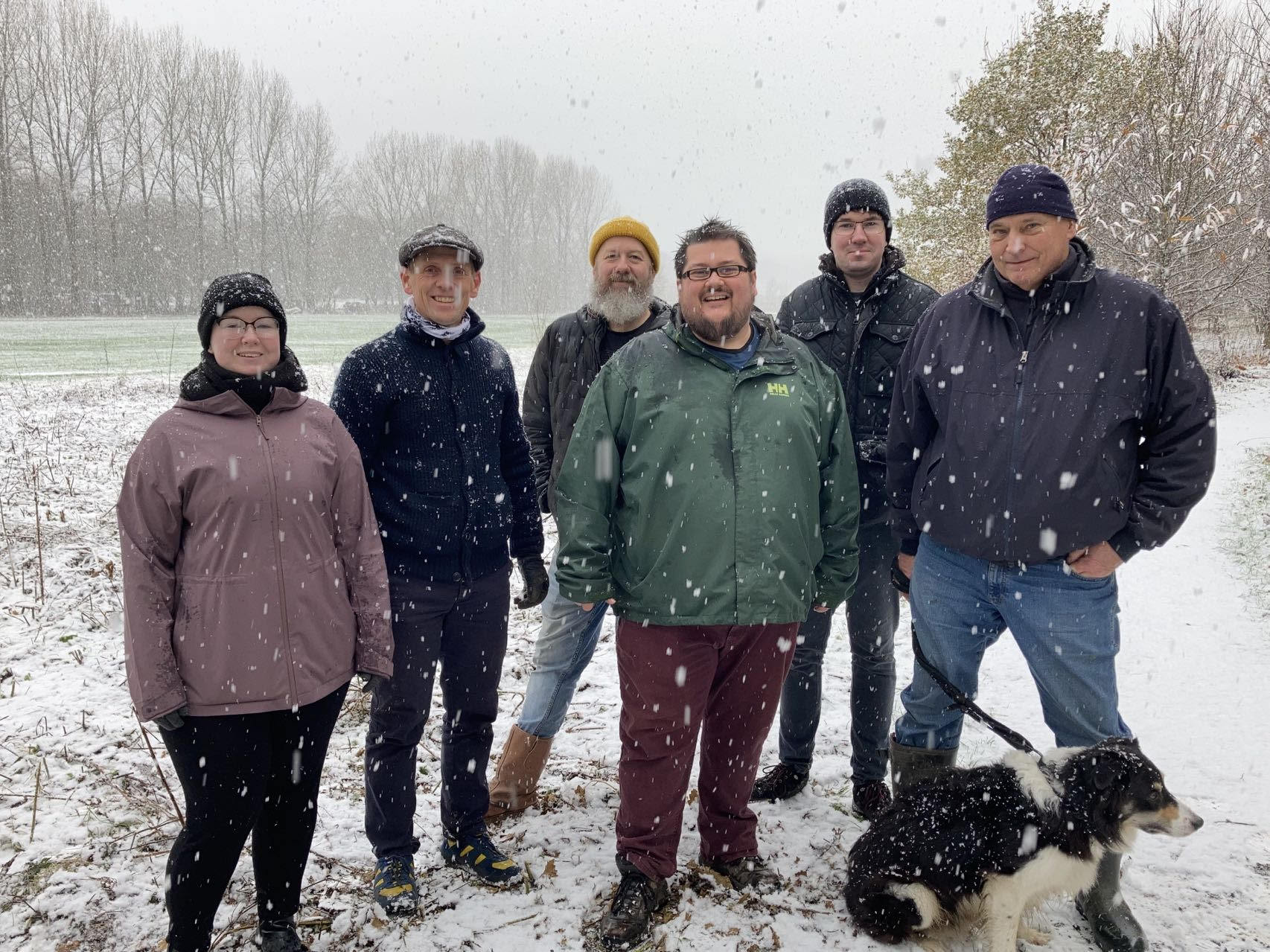 A group photo after the planting in the snow with Green members, a dog and Councillors Sarah Hall, Scott Cunliffe and Andy Fewings