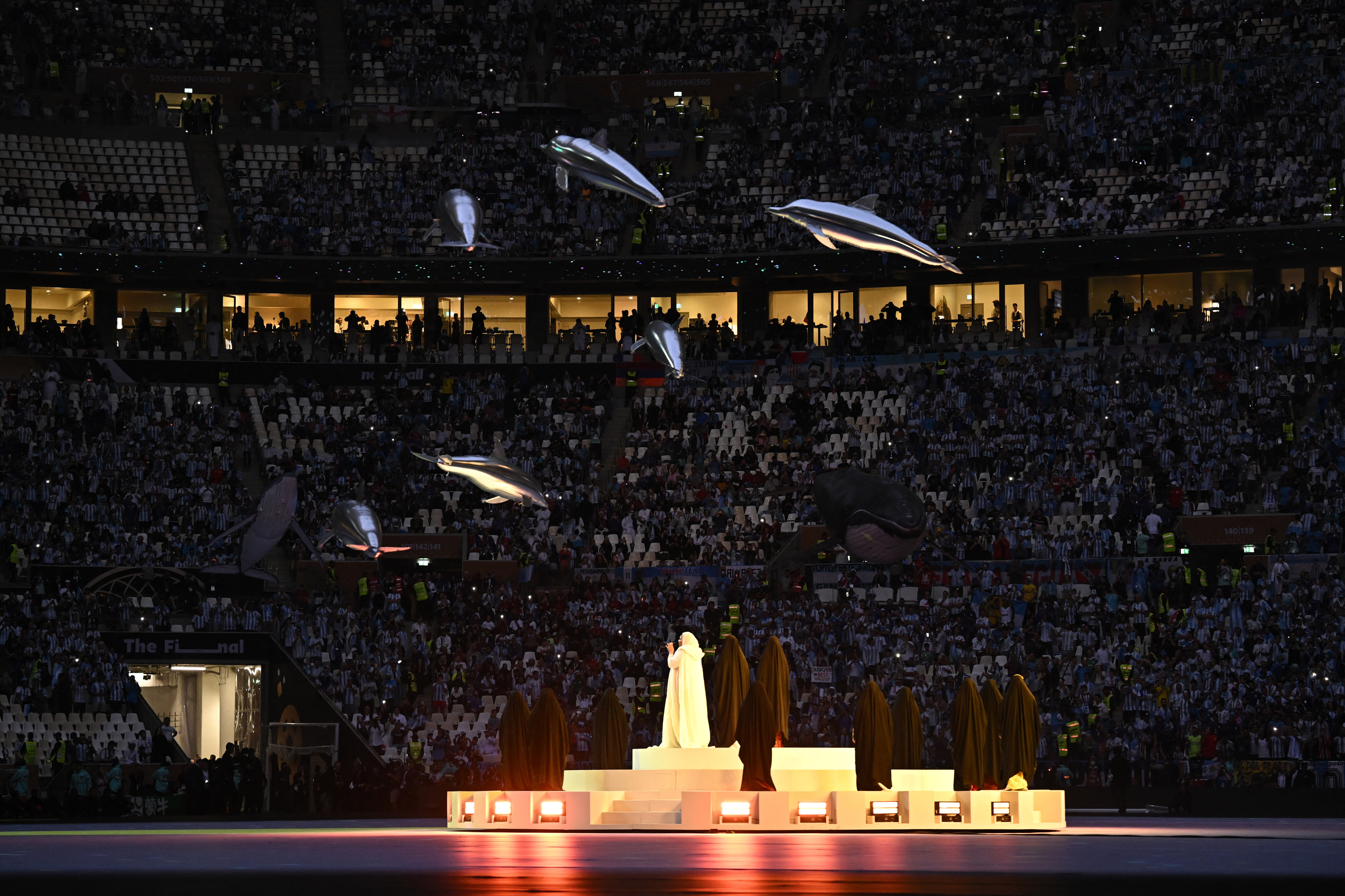 Soccer Football - FIFA World Cup Qatar 2022 - Final - Argentina v France - Lusail Stadium, Lusail, Qatar - December 18, 2022  A woman performs during the closing ceremony before the match REUTERS/Dylan Martinez