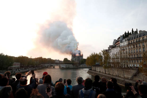Slide 18 of 31: Smoke billows from Notre Dame Cathedral after a fire broke out, in Paris, France April 15, 2019. REUTERS/Benoit Tessier - RC1D05B4B370