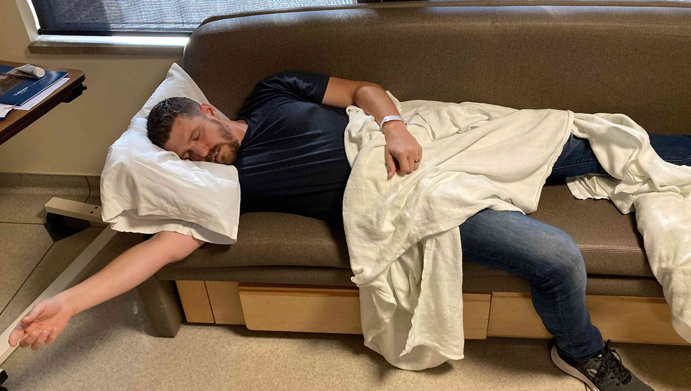 New Dad Recovering After Spending Night On Uncomfortable Hospital Bench With Limited Snacks