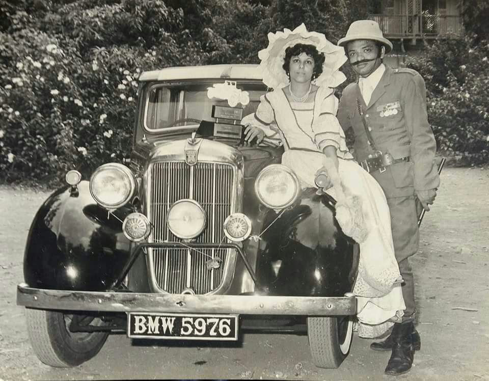 Kersi with wife during a Parsi dress competition standing next to their vintage Morris. Kersi with wife during a Parsi dress competition standing next to their vintage Morris.
