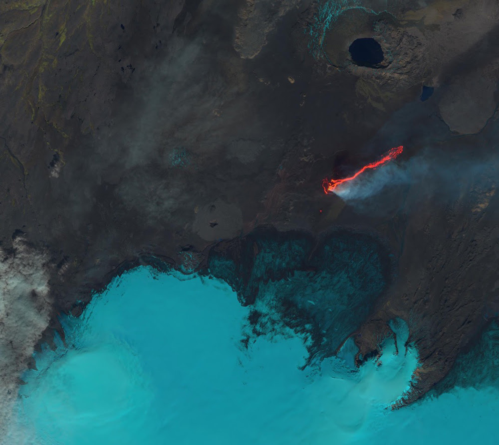 This Landsat 8 image, acquired on September 6, 2014, is a false-color view of the Holuhraun lava field north of Vatnajökull glacier in Iceland. The image combines shortwave infrared, near infrared, and green light to distinguish between cooler ice and steam and hot extruded lava. The Bárðarbunga caldera, visible in the lower left of the image under the ice cap, experienced a large-scale collapse starting in mid-August. Credit: USGS