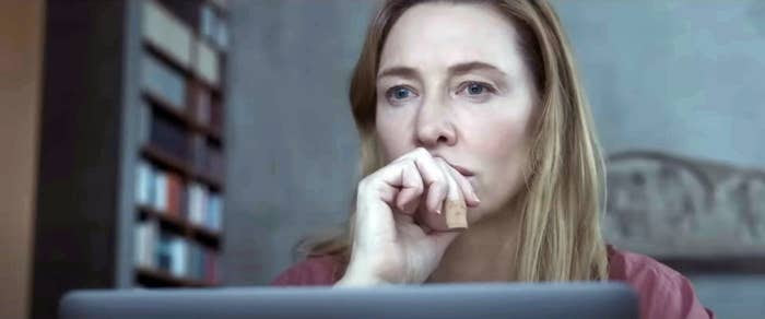 Cate Blanchett as Lydia staring off into the distance sitting in front of a laptop