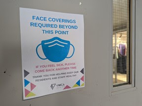 A sign on the front doors of the Regina YWCA on Aug. 19, 2022 alerts visitors of a temporary mask mandate currently in place from Aug. 19 to Sept. 9 in light of a recent surge in COVID-19 in Saskatchewan.