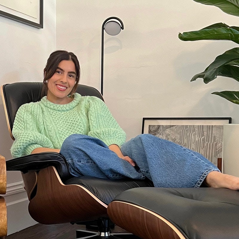 Eauso Vert cofounder Tanya Gonzalez sits in her classic Eames chair which she bought when she finished her MBA in 2022 after having it on a mood board since 2016.