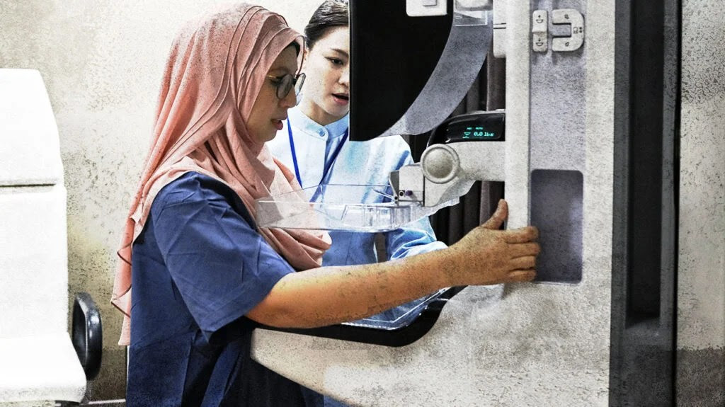 A woman having a mammogram.