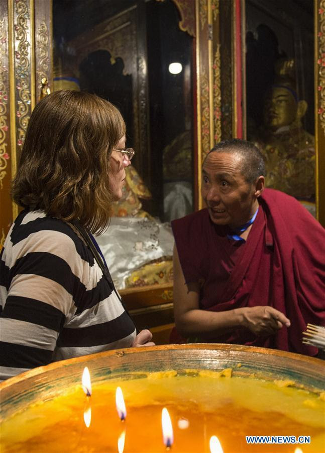 LHASA, July 4, 2016 (Xinhua) -- A monk guide introduces the history of Jokhang Temple to a foreign expert representative in Lhasa, capital of southwest China