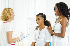 Health professional with young patient and guardian