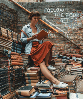 Women reading books on a pile of
 books