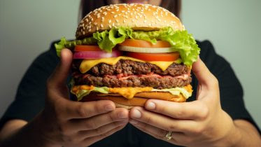 Holding Giant Hamburger Art Concept